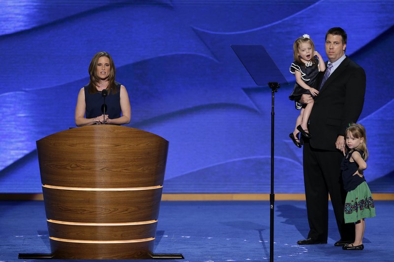 Stacey Lihn addresses the Democratic National Convention in Charlotte last week as her husband, Caleb, listens with daughters Zoe, left, and Emerson. Lihn credited the Affordable Care Act with saving one daughter’s life.