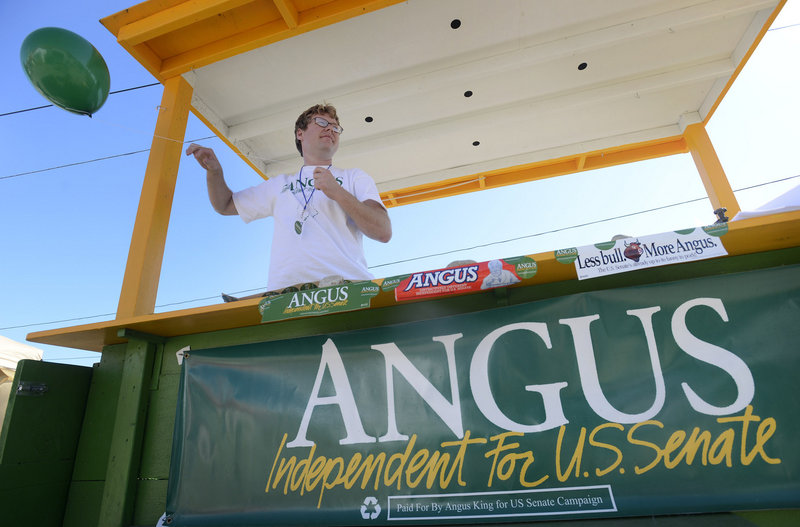 Ryan Boyd, field assistant with the Angus King for U.S. Senate Campaign, ties a balloon up to the campaign's fair booth at the Cumberland County Fair on Tuesday, Sept. 25, 2012.