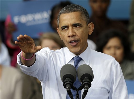 FILE - This Oct. 24, 2012 file photo shows President Barack Obama gestures while speaking to supporters during a campaign stop at The Mississippi Valley Fairgrounds in Davenport, Iowa. President Barack Obama and Republican rival Mitt Romney are on guard for anything that could tip a presidential race that polls show is close. An autumn surprise is just that, making most late-breaking events tough to plan for. (AP Photo/Charlie Neibergall, File)