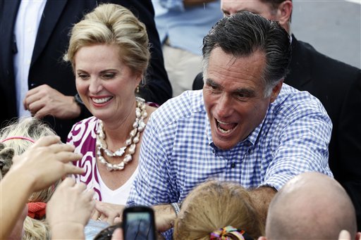 FILE - In this Oct. 7, 2012 file photo, Republican presidential candidate and former Massachusetts Gov. Mitt Romney, and wife Ann, campaign in Port St. Lucie, Fla. Mitt Romney�s campaign is working hard to chip away at President Barack Obama�s advantage among early voters, and there are signs the effort is paying off in North Carolina and Florida, two competitive states that the Republican nominee can ill afford to lose. Obama is doing better in Iowa, another battleground state important to both candidates. (AP Photo/Charles Dharapak, File)