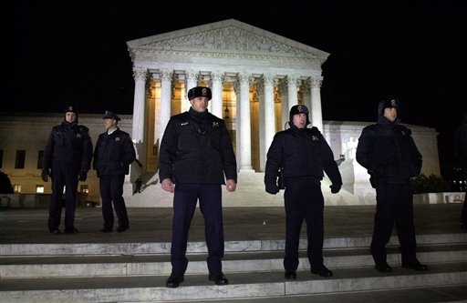 FILE - This Dec. 12, 2000 file photo shows Supreme Court police lining the steps of the court in Washington, as the nation awaits the court's ruling on the Florida presidential election. The mere mention of the 2000 election unsettles people in Palm Beach County. The county�s poorly designed �butterfly ballot� confused thousands of voters, arguably costing Democrat Al Gore the state, and thereby the presidency. Gore won the national popular vote by more than a half-million ballots. But George W. Bush became president after the Supreme Court decided, 5-4, to halt further Florida recounts, more than a month after Election Day. Bush carried the state by 537 votes, enough for an Electoral College edge, and the White House. (AP Photo/Kenneth Lambert, File)