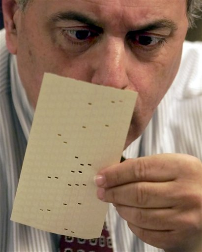 FILE - In this Nov. 22, 2000 file photo, Broward County, Fla. canvassing board member Judge Robert Rosenberg examines a challenged vote at the Broward County Emergency Operations Center in Plantation, Fla. The mere mention of the 2000 election unsettles people in Palm Beach County. The county�s poorly designed �butterfly ballot� confused thousands of voters, arguably costing Democrat Al Gore the state, and thereby the presidency. Gore won the national popular vote by more than a half-million ballots. But George W. Bush became president after the Supreme Court decided, 5-4, to halt further Florida recounts, more than a month after Election Day. Bush carried the state by 537 votes, enough for an Electoral College edge, and the White House. (AP Photo/Wilfredo Lee, File)