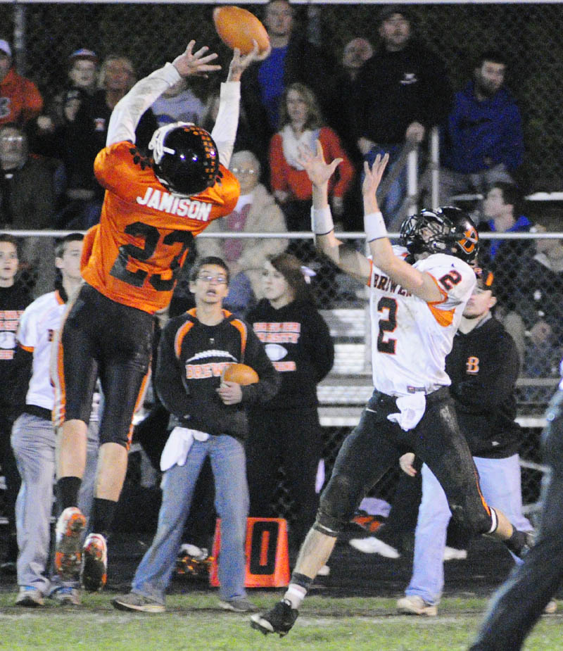 Gardiner's Tyler Jamison, left, tips a pass intended for Brewer receiver Spencer Valley during a game on Friday night at Hoch Field in Gardiner.