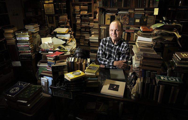 John Merrill, owner of Merrill’s Bookshop on Water Street in Hallowell, says he believes his small business will suffer if Mitt Romney is elected president.