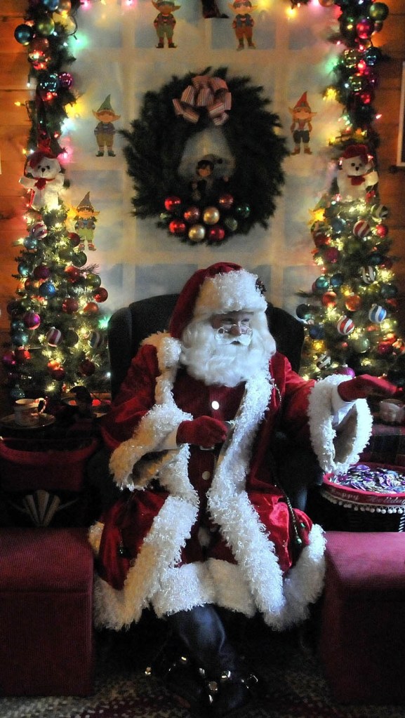 Santa Claus says "goodbye" to some children, at Kringleville in Castonguay Square in downtown Waterville, on Saturday.