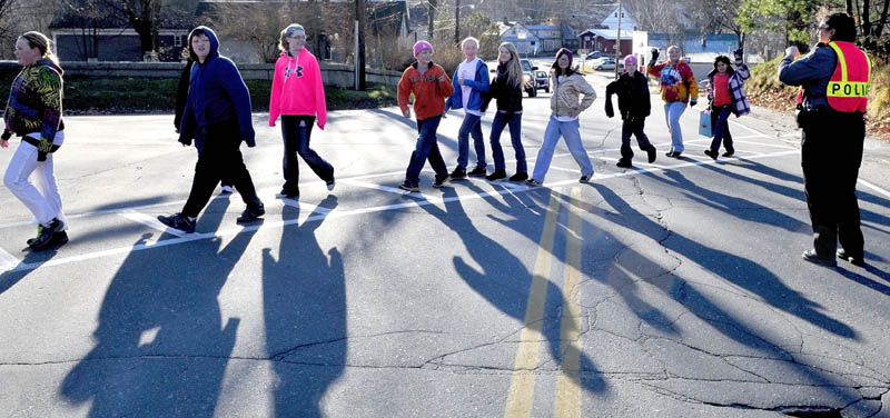 Wilton Police Chief Heidi Wilcox stops traffic as students cross Main Street near the Academy Hill School on Wednesday. The kids took part in the annual food drive and donated food they collected to the Wilton Food Pantry. "This is a fantastic event that the kids do," Wilcox said.