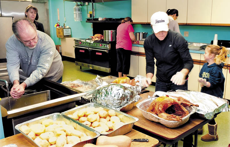 Staff and volunteers with the Skowhegan Community Center on Wednesday pitched in to prepare free Thanksgiving meals to all who stop in between 11 a.m. and 1 p.m. today. From left are John Doucette Jr., Mary Humphrey, Donna McDaniel, Denise Leblanc, Bethanie Sevey, back, and Laney Leblanc.