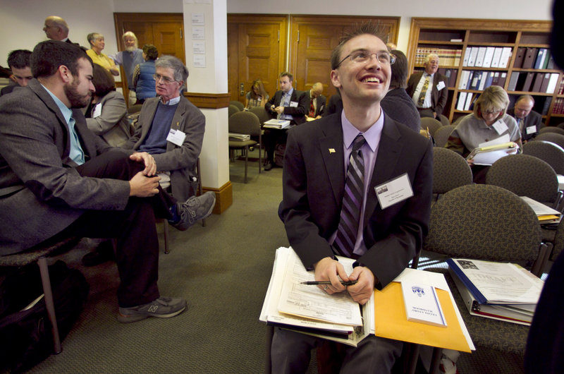 State Rep.-elect Justin Chenette, D-Saco, right, chats with a colleague during freshman orientation Thursday at the State House. Chenette, 21, is the Legislature’s youngest member.