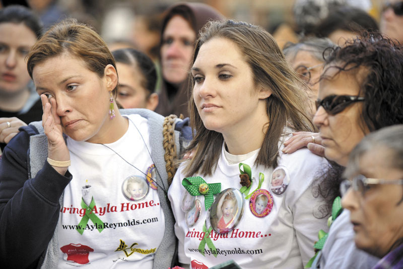 FOR AYLA: A rally was held in support of missing toddler Ayla Reynolds in Portland’s Monument Square on Wednesday, her second birthday. Ayla’s mother, Trista Reynolds, right, and her friends, including Ashley Pouliot, left, listen to a song written for Ayla by musician Alan Pouliot, of Fairfield. Ayla was reported missing from her Waterville home on Dec. 17.