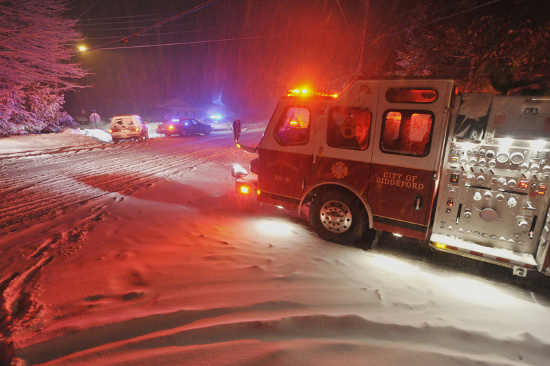 A fire truck idles at the intersection of Pool and Sokokis roads in Biddeford Saturday night, responding to the scene of a multiple shooting. According to Maine Department of Public Safety spokesman Steve McCausland, two people were killed and a suspect was taken into custody.