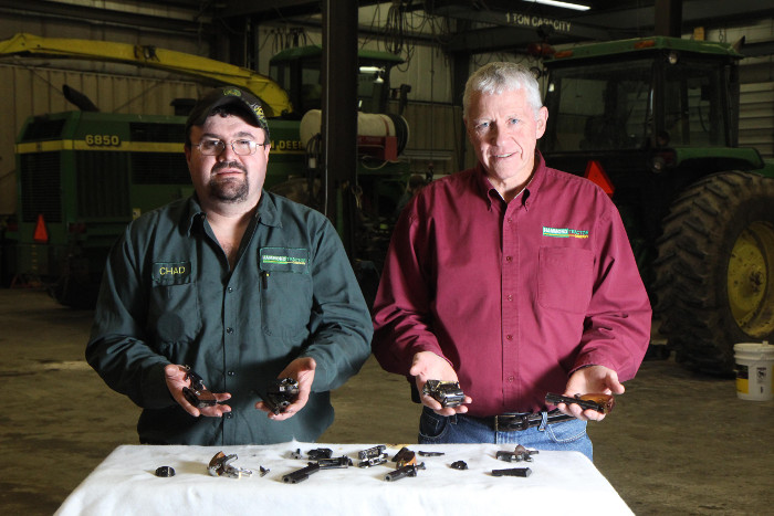 Hammond Tractor Co. co-owner Gary Hammond, right, and employee Chad Tibbetts hold pieces of destroyed firearms in Fairfield on Friday. In the wake of the Newtown, Conn. shooting, Hammond Tractor is offering to accept and destroy firearms. "We're all hunters and we all own guns, but as an act of service to the community if any one has guns they want destroyed we'll gladly do that for them, " said Hammond.