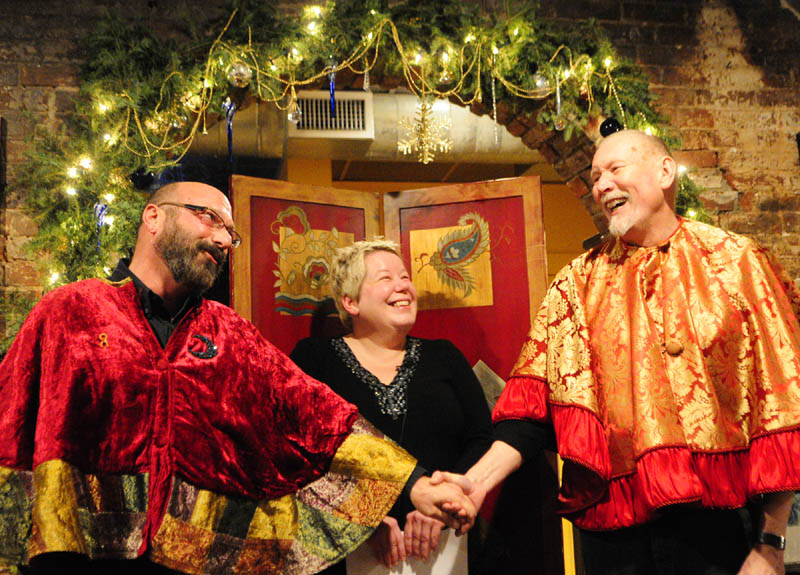 Brian Kaufman, left, and Martin Swinger, right, sing "Stuck On You," from the musical "Whoop-Dee-Doo!," to each other during their wedding on Saturday at Slates Restaurant in Hallowell. Their wedding was officiated by Hallowell Mayor Charlotte Warren, center.