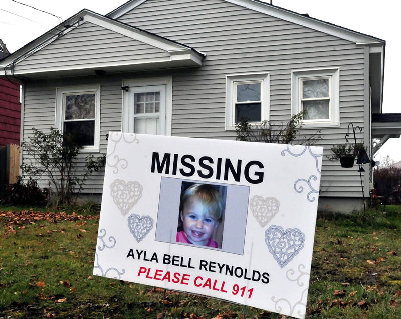 A sign and photograph of Ayla Reynolds has been placed in front of 29 Violette Ave. in Waterville, where she was reported missing nearly a year ago, on Nov. 25.