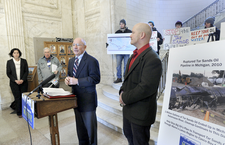 Portland Mayor Michael Brennan, center, joins Emily Figdor, left, of Enviroment Maine, Eliot Stanley of the Sebago Lake Anglers Association and City Councilor David Marshall, right, at a news conference at Portland City Hall to endorse a tar sands-free Portland to be voted on by the city council on Wednesday.