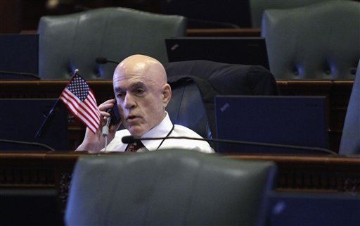 FILE - In this May 30, 2012 file photo, Illinois Rep. Greg Harris, D-Chicago, works at his desk as the lone lawmaker in the House chambers before the beginning of the day's legislative session at the Illinois State Capitol in Springfield, Ill. Advocates of legalized gay marriage in Illinois are pleased that Harris and state Sen. Heather Steans are planning to push for approval in January. Harris and Steans say they believe they have the votes necessary to fulfill Gov. Pat Quinn's hope of signing same-sex marriage into law in January. (AP Photo/Seth Perlman, File)