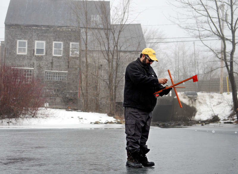 Peter Boulette, of Waterville, retrieves an ice fishing trap Sunday during an excursion on Minnehonk Lake in Mount Vernon. Boulette and his buddies, Todd Dostie and Adan Lawlor, said they encountered several flags while fishing on the ice, but only caught bass and pickerel.