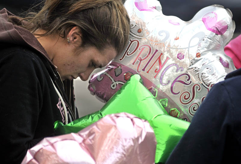 Trista Reynolds takes a moment during a vigil in Castonguay Square in Waterville for her missing toddler, Ayla Reynolds, on Jan 28.