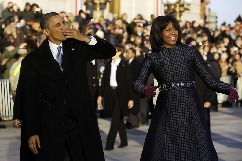 President Obama blows a kiss as he and first lady Michelle Obama walk on Pennsylvania Avenue near the White House during the Inauguration Parade. The ceremonies included appearances by pop-culture icons, including Beyonce, who sang the national anthem.