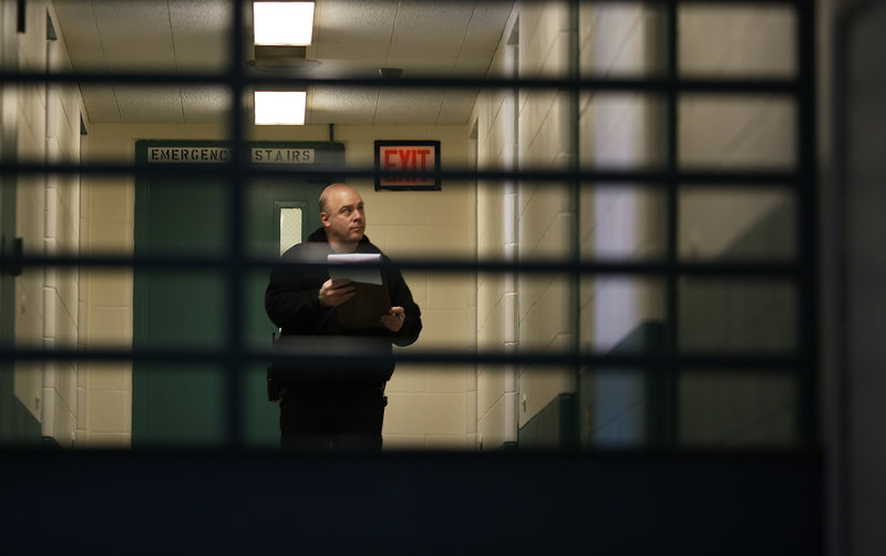 Corrections Officer Gary Osgood performs noontime checks at the Maine Correctional Center in Windham on Friday.