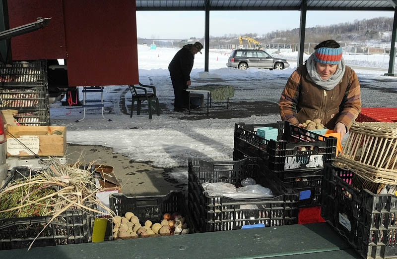 Charlie Erskine, of Erskine Farms, left, and Dalziel Lewis, of Dig Deep Farm, set up under the gazebo for the weekly farmers' market on Tuesday in Mill Park in Augusta. The winter market runs every Tuesday from 12:30 to 2 p.m. through May, when the hours will change. Mill Park is on Northern Avenue, between downtown and Sand Hill.