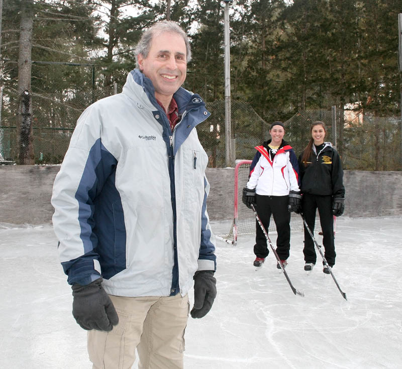 Mike Nawfel built a ice rink in his backyard in Waterville for his daughters and their friends.