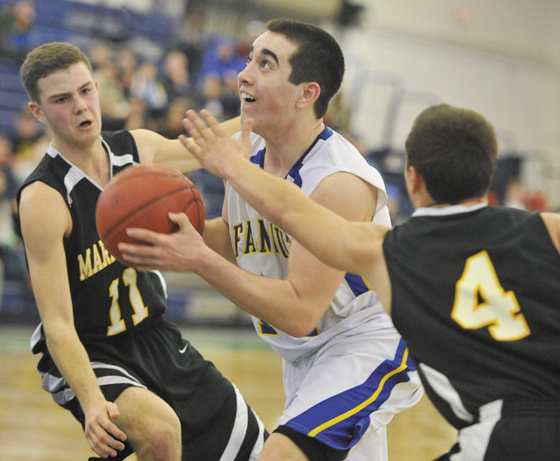 TO THE HOOP: Falmouth’s Thomas Coyne drives to the basket by Maranacook’s Taylor Wilbur, left, during a Western B quarterfinal game in Portland.