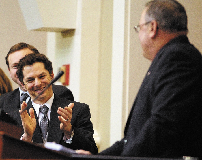 Staff photo by Joe Phelan Senate President Justin Alfon, left, claps during Gov. Paul LePage's State of the State address on Tuesday February 5, 2013 in the State House in Augusta.