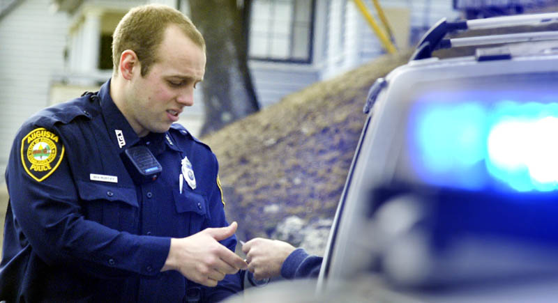 Augusta Police Officer Ben Murtiff speaks with a driver Wednesday in Augusta.