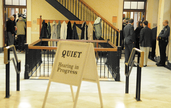 Spectators watch from hallway during hearing on L.D. 345 in a crowded hearing before the Judiciary Committee Tuesday at the State House in Augusta. There were people seated in at least two other hearing rooms listening in.