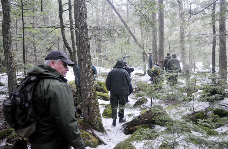 Staff photo by Andy Molloy Game Wardens, State Police and Somerset County Sheriff's deputies hike into Christopher Knight's camp site in Rome Tuesday April 9, 2013. Police believe Knight, who went into the woods near Belgrade in 1986, was a hermit who committed hundreds of burglaries to sustain himself. The camp was located in a heavily wooded location.