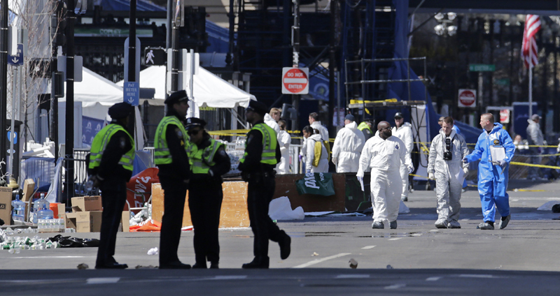 Police and investigators work on Boylston Street, near the finish line of Monday's Boston Marathon.