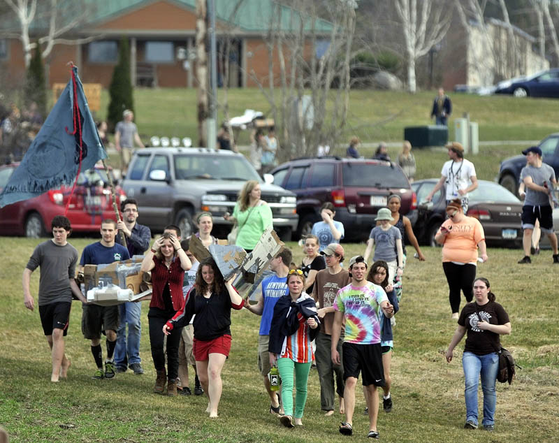 During the first cardboard kayak race at Unity College on Friday, students had one hour to fabricate kayaks from cardboard, tape and plastic, then race them.