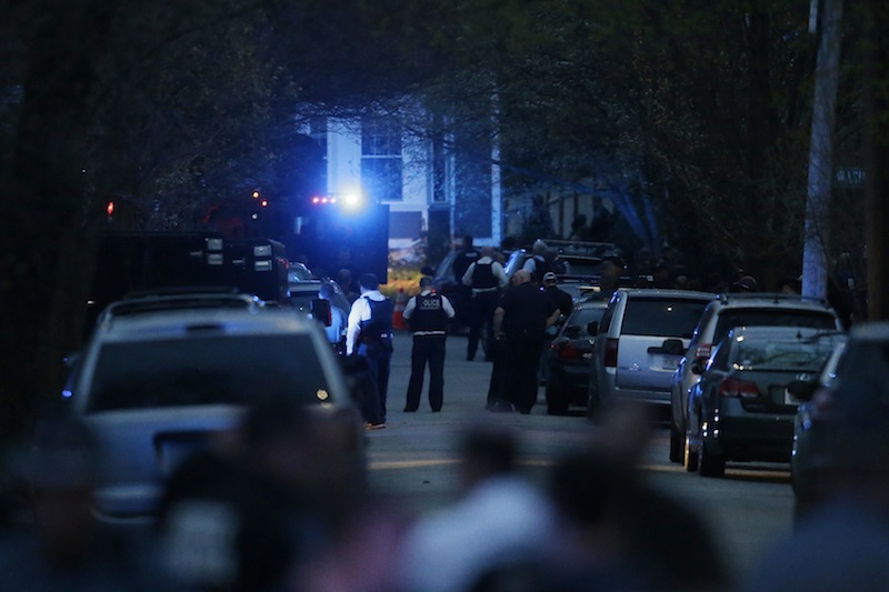 Law enforcement search for the suspect in the Boston Marathon bombings, Friday, April 19, 2013, in Watertown, Mass. Gunfire erupted Friday night amid the manhunt for the surviving suspect in the Boston Marathon bombing, and police in armored vehicles and tactical gear rushed into the Watertown neighborhood in a possible break in the case. (AP Photo/Matt Rourke)