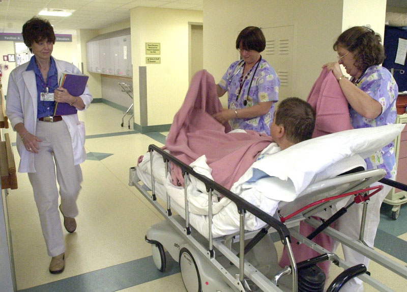 In this file photo, Linda Farley and Sharon Wallace care for a patient at Maine Medical Center in Portland. Democratic lawmakers want to combine a decision on Medicaid expansion with a proposal to pay a $186 million debt to hospitals.