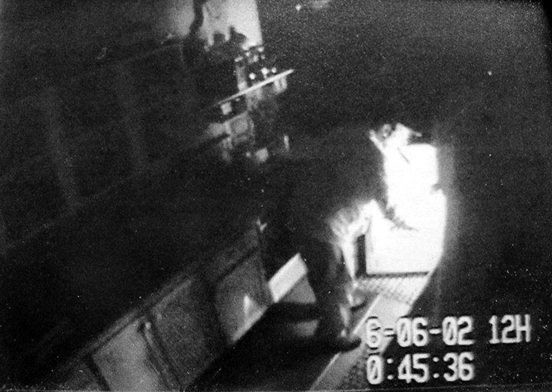 A surveillance photo shows a person, alleged to be Christopher Knight, the North Pond Hermit, burglarizing a structure. Some of the hundreds of those whose camps and homes were allegedly burglarized by Knight feel sympathy for the man, who reportedly survived 27 years in the Rome woods by pilfering food and supplies; others feel violated, and say they're glad he's locked up.