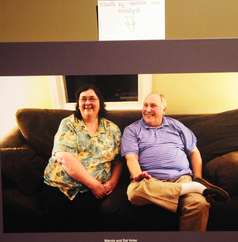 A note above a photo of Malaga descendant Marnie Voter, left, and her husband, Del Voter, in the "Malaga Island, Fragmented Lives" exhibition, reads "That's My Gramie and Grandpa," at the Maine State Museum in Augusta.