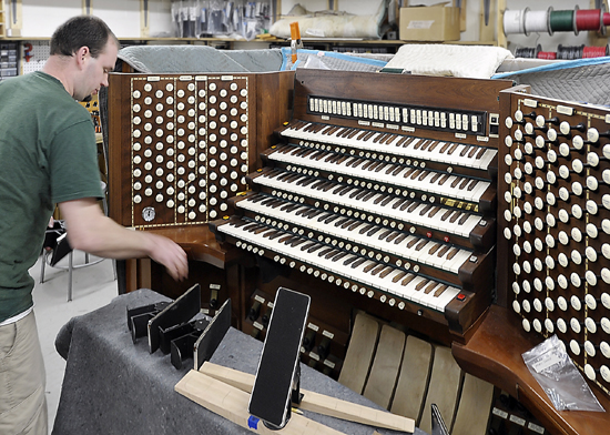 Adam Lagocki works on The Console of the organ as he and other technicians work on refurbishing the Kotzschmar Organ from Merrill Auditorium in Portland, Maine at Foley-Baker, Inc. in Toland, Connecticut.