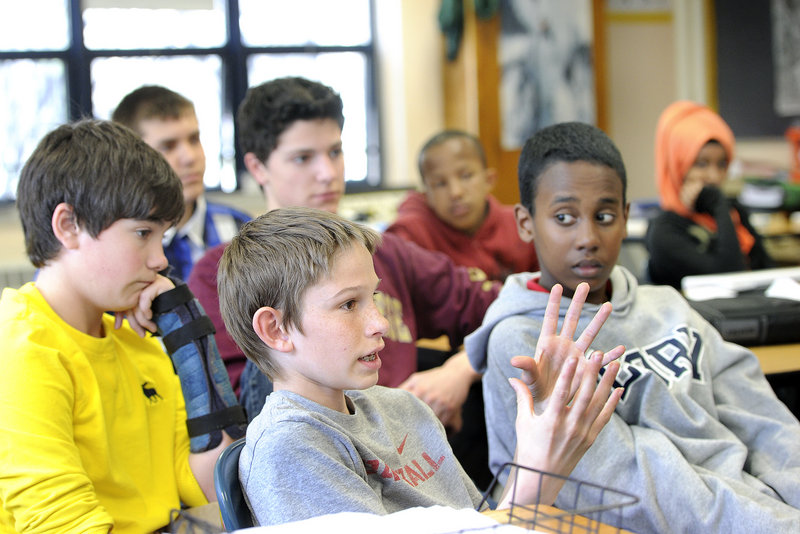 King Middle School social studies teacher Paul Clifford talks with his students about recent headlines from Boston during his class Monday, April 22, 2013. 13-year-old Kenneth Barnard, of Portland, is among students participating in the discussion.