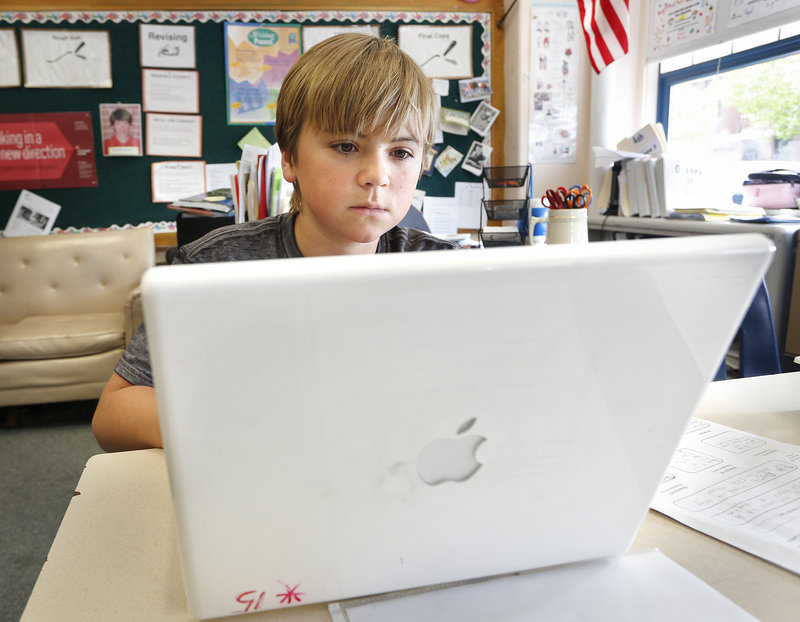 Sixth-grader Cole McGhie works on a laptop computer, Tuesday, May 27, 2013, during class at King Middle School. Gov. Paul LePage considered shutting down Maine's school laptop program last fall, new e-mails show.