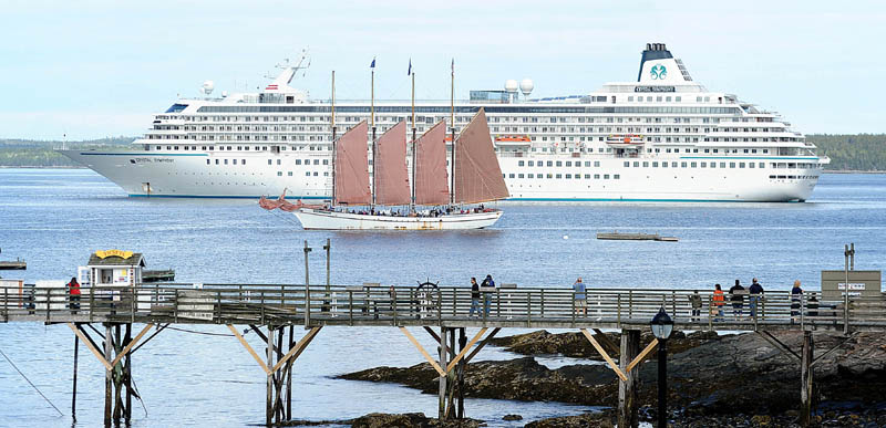The Margaret Todd, a 151-foot-long, four-masted schooner, is dwarfed by the anchored, 51,000-ton Crystal Symphony cruise liner in Bar Harbor on Monday.