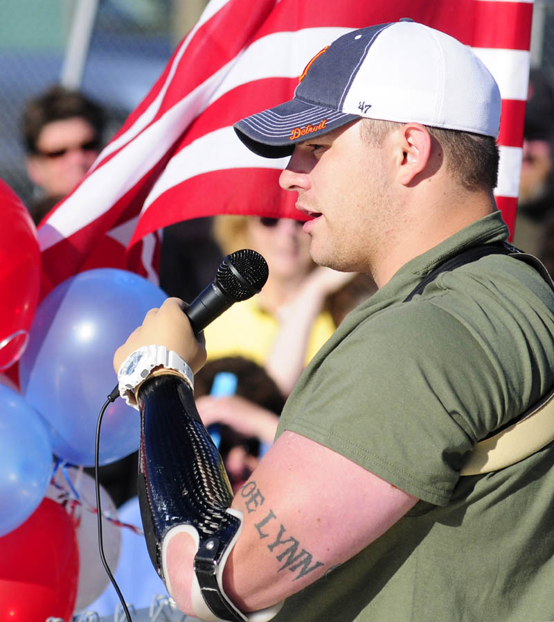 Staff Sgt. Travis Mills talks to the crowd before the start of the second annual Miles For Mills 5k on Monday at Cony High School in Augusta.