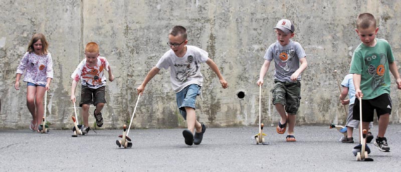 Area youngsters stage an impromptu wooden duck race outside the Gardiner Post Office on Saturday during the Greater Gardiner River Festival, which kicked off the annual Whatever Family Festival. From left to right are Dakota Lovely, Zachary Hanley, Michael Hanley, Benjamin Tobey and Joseph Hanley.