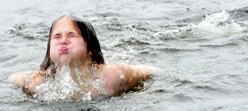 Emma Fogg took advantage of the warm and dry Thursday and went for a dip with friends in Messlonskee Lake in Oakland. Asked how the water temperature was, Fogg replied, "Kinda cool and kinda warm."