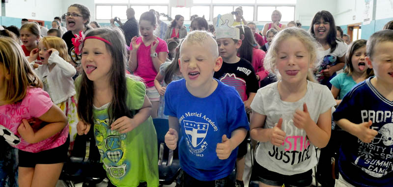 Kids at Mount Merici Academy in Waterville take part in the school's traditional "Tootie-ta" skit during an end of the year assembly on Thursday. Sticking out their tongues are, from left, Braelyn Doody, Michael Achorn and Briana Veilleux.