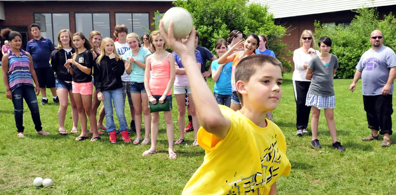 Waterville Junior High School seventh grade student Tyler Dunn throws a ball during a dunk tank fundraiser for him on Monday. Dunn is undergoing open-heart surgery in August. Students paid to throw balls and dunk school staff. A sphagetti dinner and auction fundraiser for the Dunn family will be held June 22 at 5 p.m. at the George Mitchell School. Asked how he felt about the support from friends and teachers, Dunn said, "It makes me feel happy."