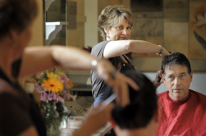 Gabe Souza/Staff Photographer Holly Fent, shown cutting the hair of Peter McDonald of Scarborough at Hair It Is on St. John Street, recognizes that she can be a trusted “ sounding board,” but technology has eroded the personal touch that helped protect privacy for the previous two centuries.