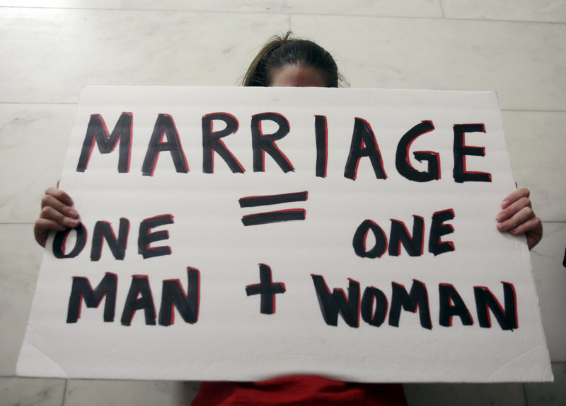 An opponent of gay marriage prays outside a Republican conference room at the Capitol in Albany, N.Y., in 2011. The issue of same-sex marriage poses major challenges for Republican leaders in Washington and around the nation.