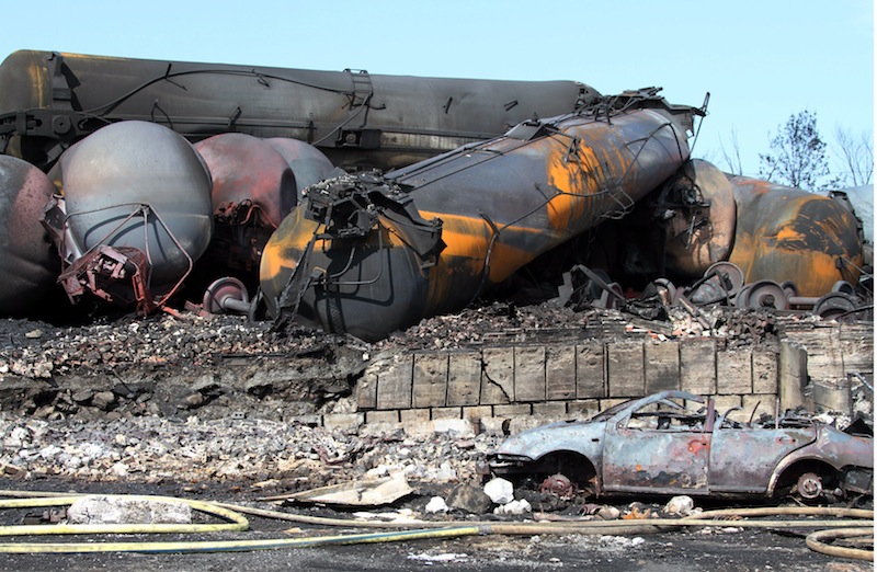 This photo provided by Surete du Quebec, shows wrecked oil tankers and debris from a runaway train on Monday, July 8, 2013 in Lac-Megantic, Quebec, Canada. A runaway train derailed igniting tanker cars carrying crude oil early Saturday, July 6 At least 50 people were confirmed dead in a catastrophe that raised questions about the safety of transporting oil by rail instead of pipeline. (AP Photo/Surete du Quebec, The Canadian Press)