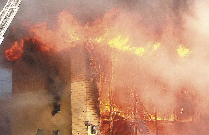 Fire consumes an apartment building in Lewiston on Monday, April 29. At least four apartment buildings were involved, with many more in peril. A 13-year-old boy accused of setting the fire in a densely populated section of downtown Lewiston was confesses in a video recording of a police interview that aired in court Monday, but his attorney wants the confession tossed out, saying the boy wasn't read his Miranda rights quickly enough.