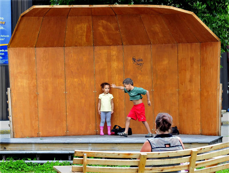 Davontay Gorham-Roy gets ready to do a cartwheel as his sister, Malia, waits her turn to perform on the stage in the Concourse in Waterville on Wednesday. Watching on a park bench is their mother, Natalie Roy.